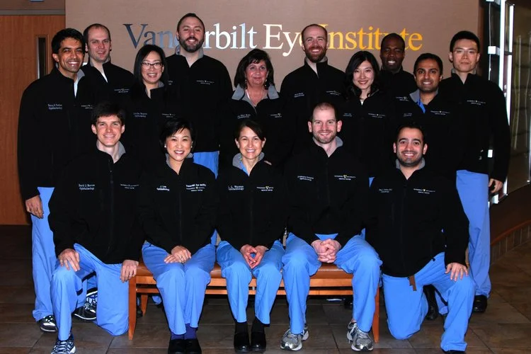 Vanderbilt Eye Institute team of 15 staff members in black jackets and blue scrubs