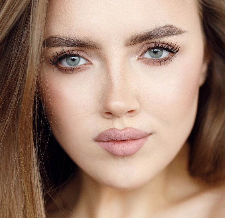 Woman's face with defined eyebrows and eye makeup