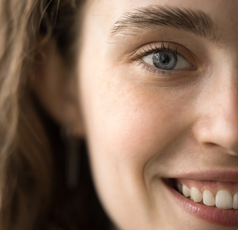 Close-up of woman's face showing eye area and smile, demonstrating facial features