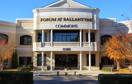 Forum at Ballantyne Commons building exterior with classical columns and autumn landscaping