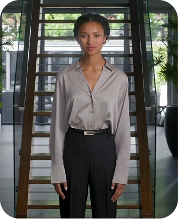 Woman in business attire standing in front of glass doors for Ethics Course