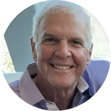 John Trimmer, older man with white hair smiling in circular profile photo