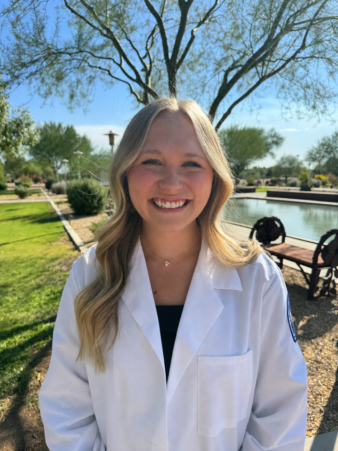 Elizabeth Dohrmann, PA, smiling outdoors in white lab coat