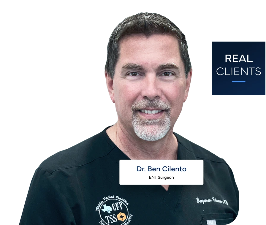 Dr. Ben Cliento, ENT Surgeon, smiling at camera wearing dark scrubs with medical badges