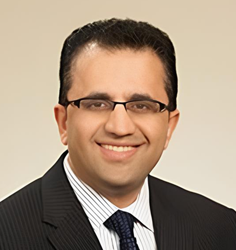 Dr. Ammar Ali, male healthcare provider wearing glasses and business attire