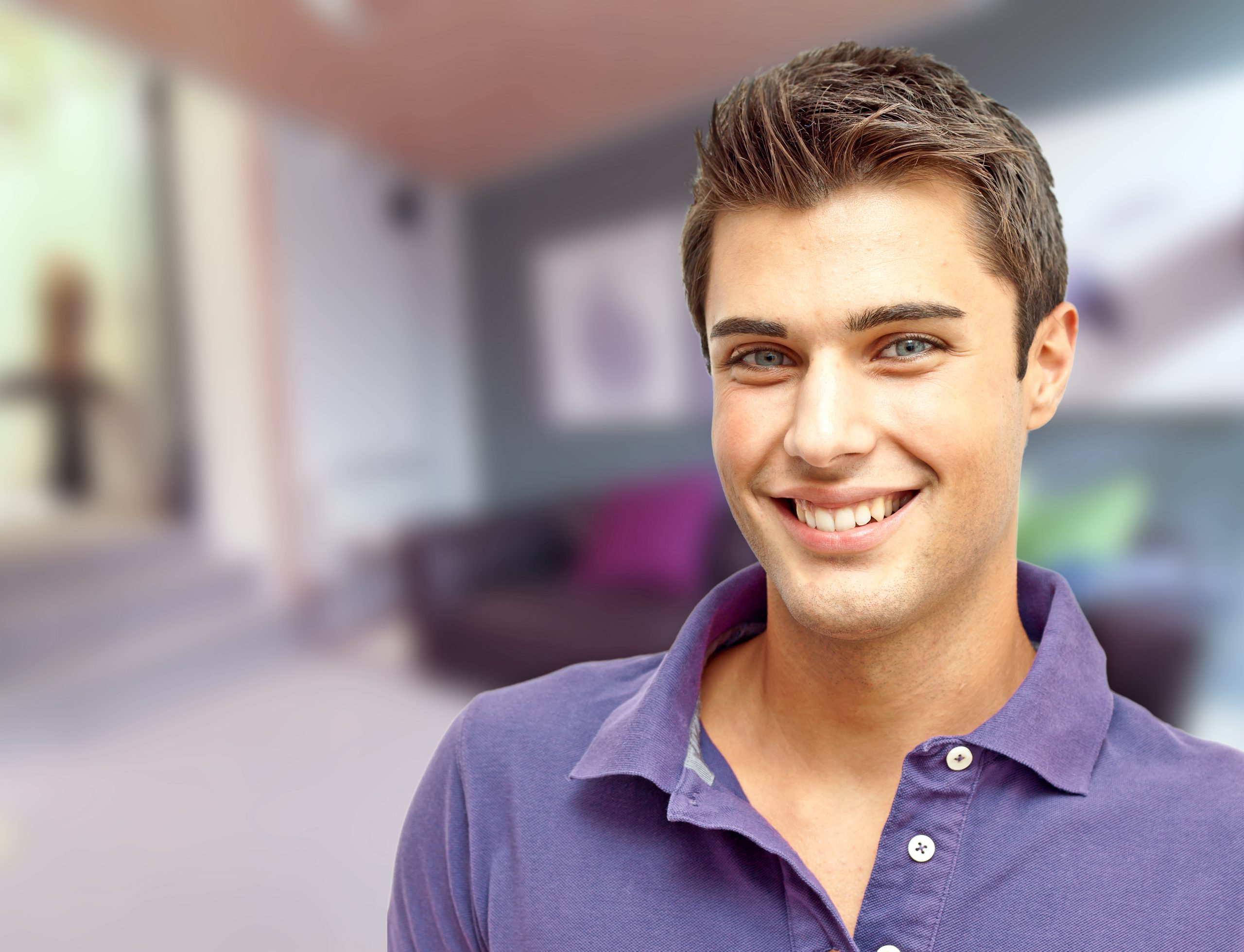 Young man smiling in modern home interior