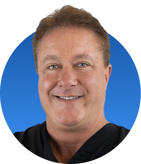 Chiropractor in black shirt smiling against blue background