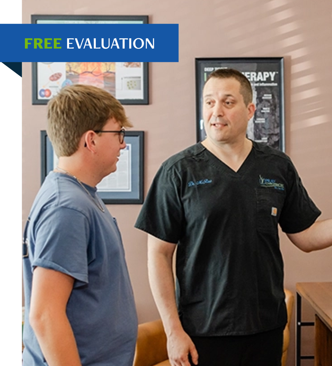 Chiropractor explaining treatment approach to patient during free evaluation