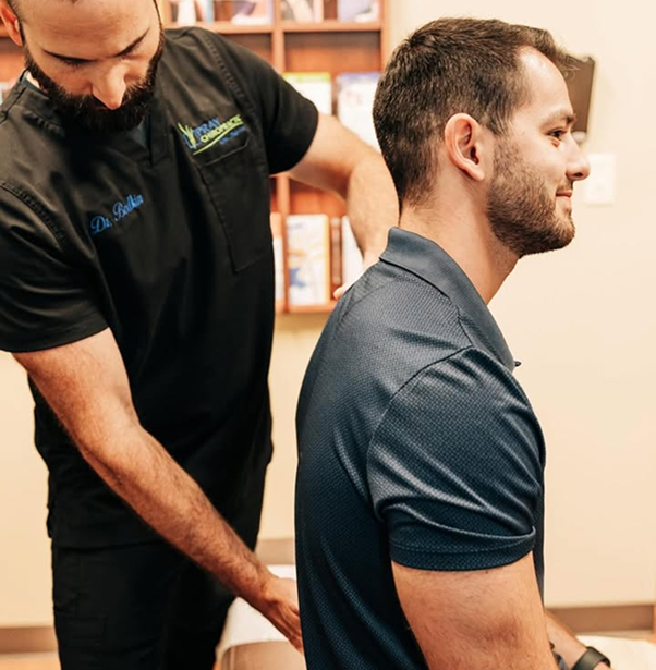 Chiropractor examining patient's spine and upper back