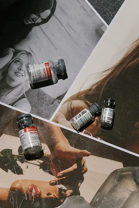 Multiple hands holding supplement bottles with product labels visible