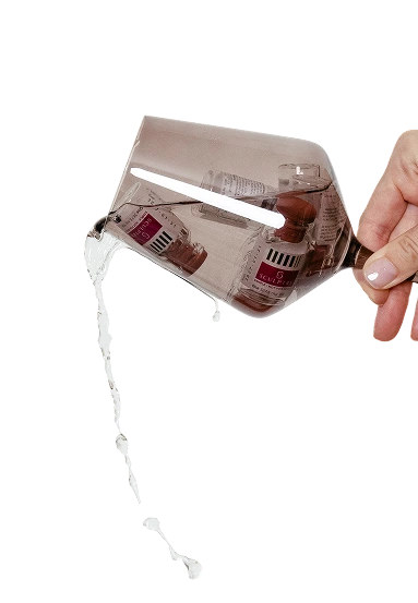 Hand holding PlasmaSculpt device with cartridge dispensing clear liquid