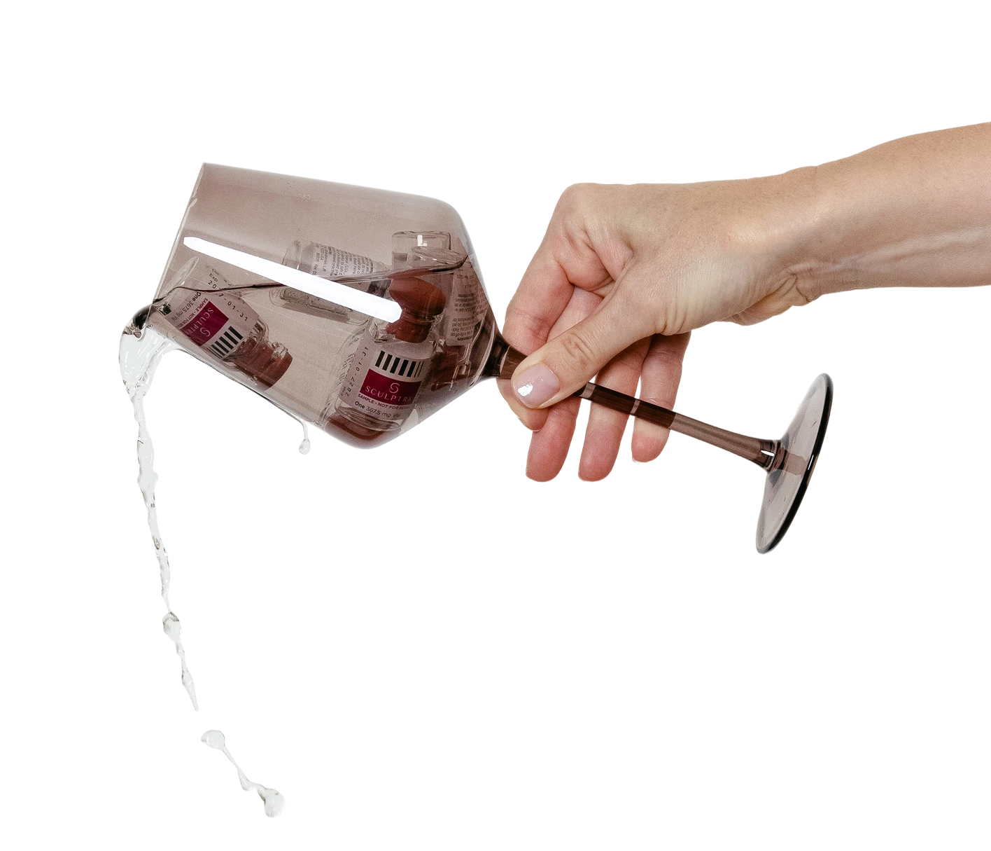 Hand holding PlasmaSculpt device with cartridge dispensing clear liquid