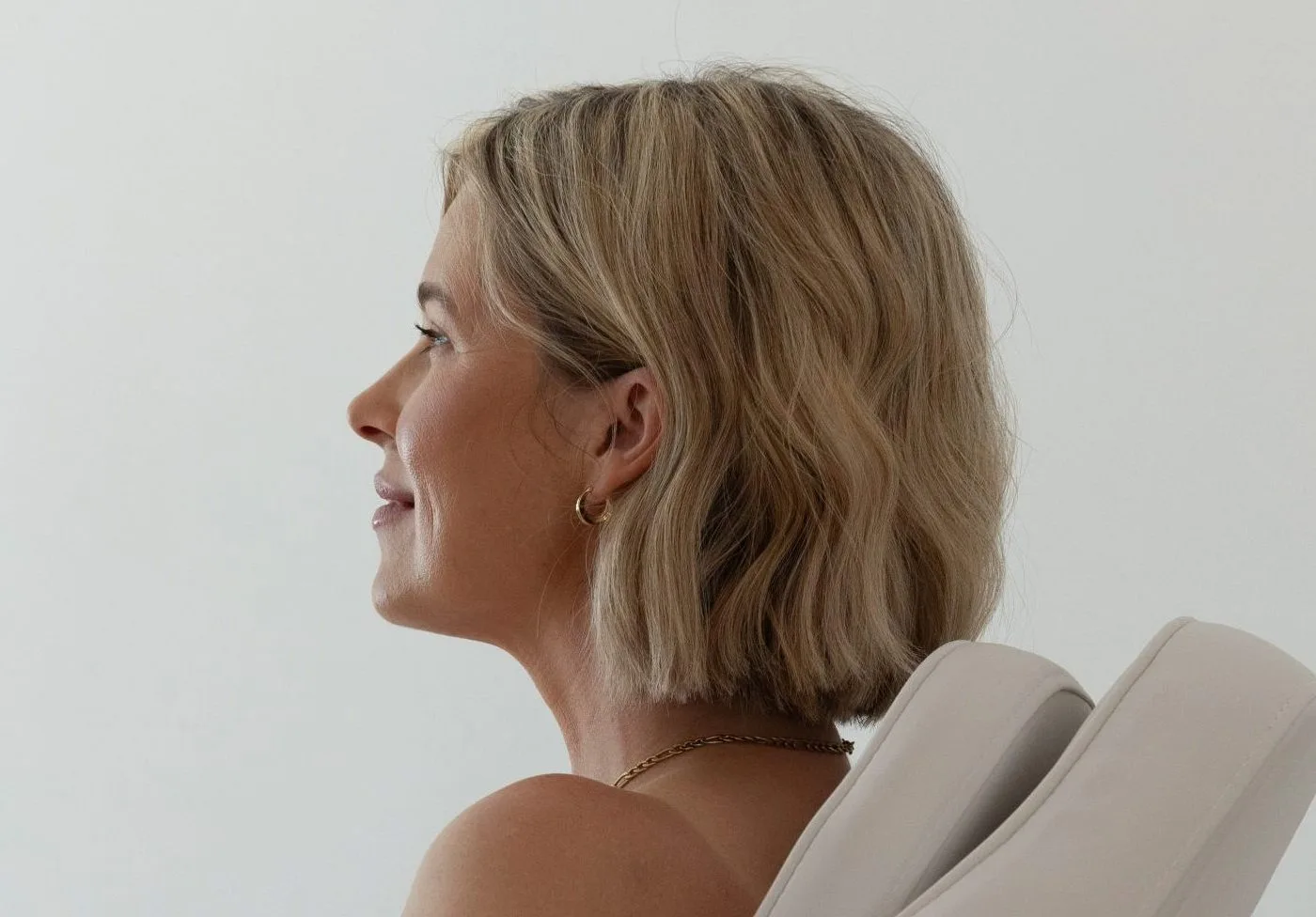 Woman in profile view with defined jawline and neck contour