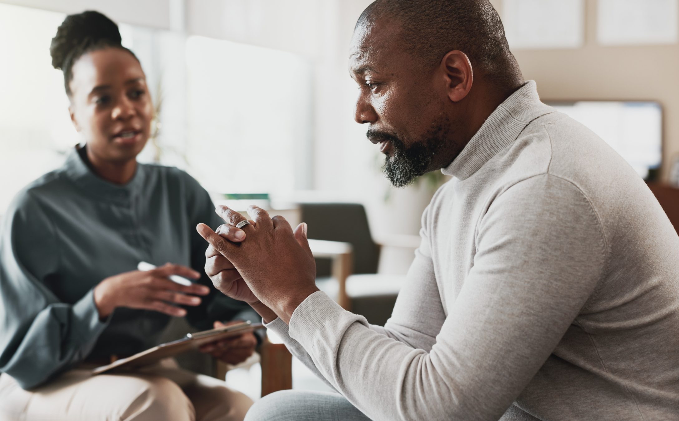 Therapist and patient having a discussion in an office setting during a counseling session