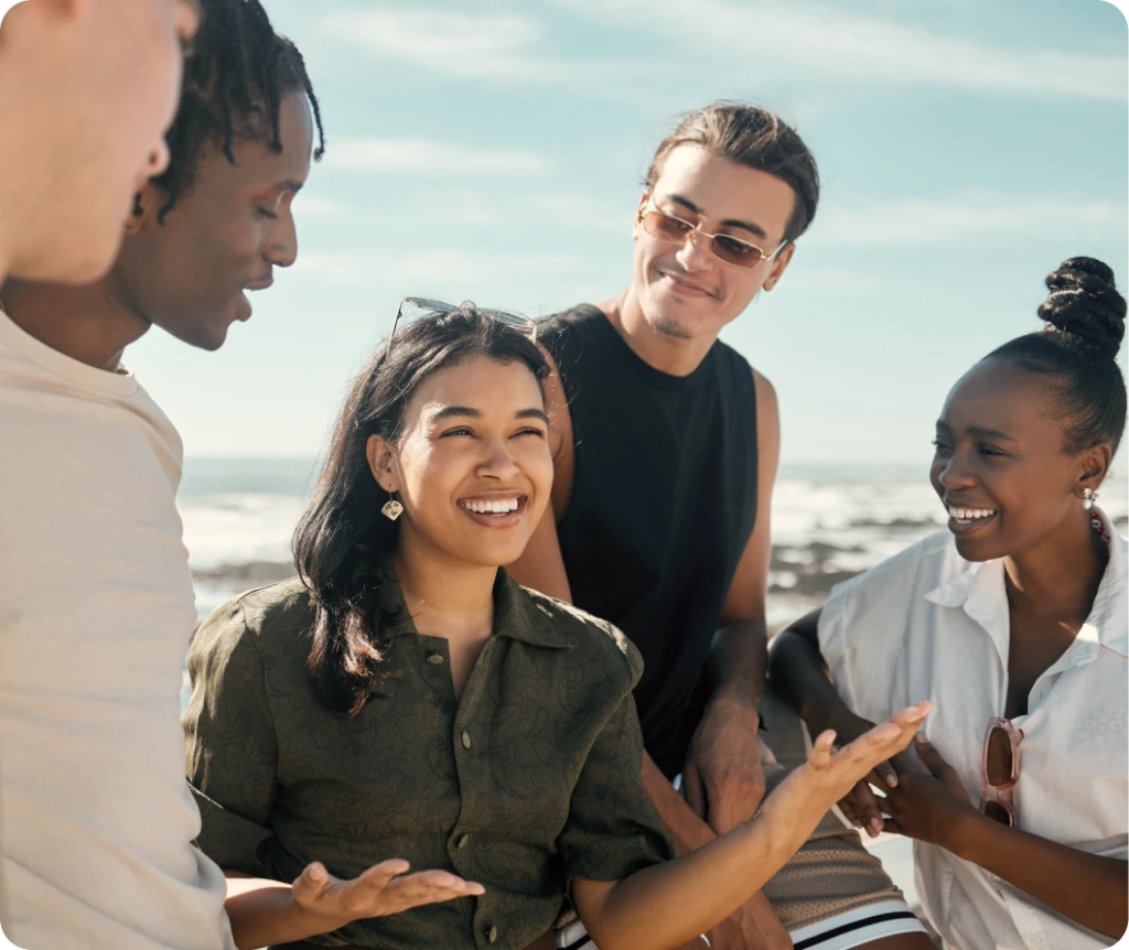 Group of friends laughing together on a beach