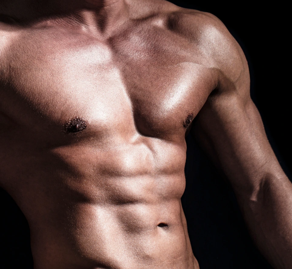 Muscular male torso showing abdominal definition against dark background