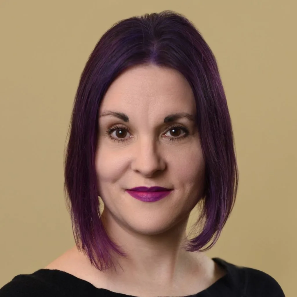 Darcy Desautels, LICSW, professional headshot against a beige background