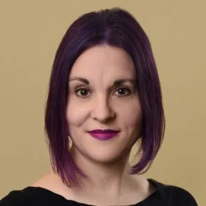 Darcy Desautels, LICSW, professional headshot against a beige background
