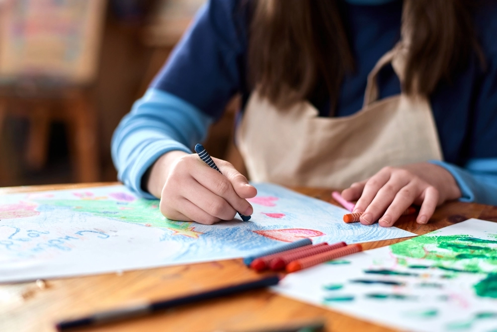 Close Up Of Unrecognizable Teen Girl Drawing Picture With Crayons