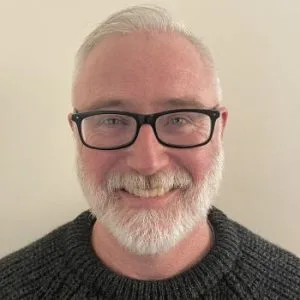 Ed O'Brien, LMHC-A, a therapist at The Psyched Group, smiling at the camera