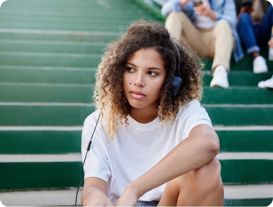 Teen girl sitting alone on school bleachers