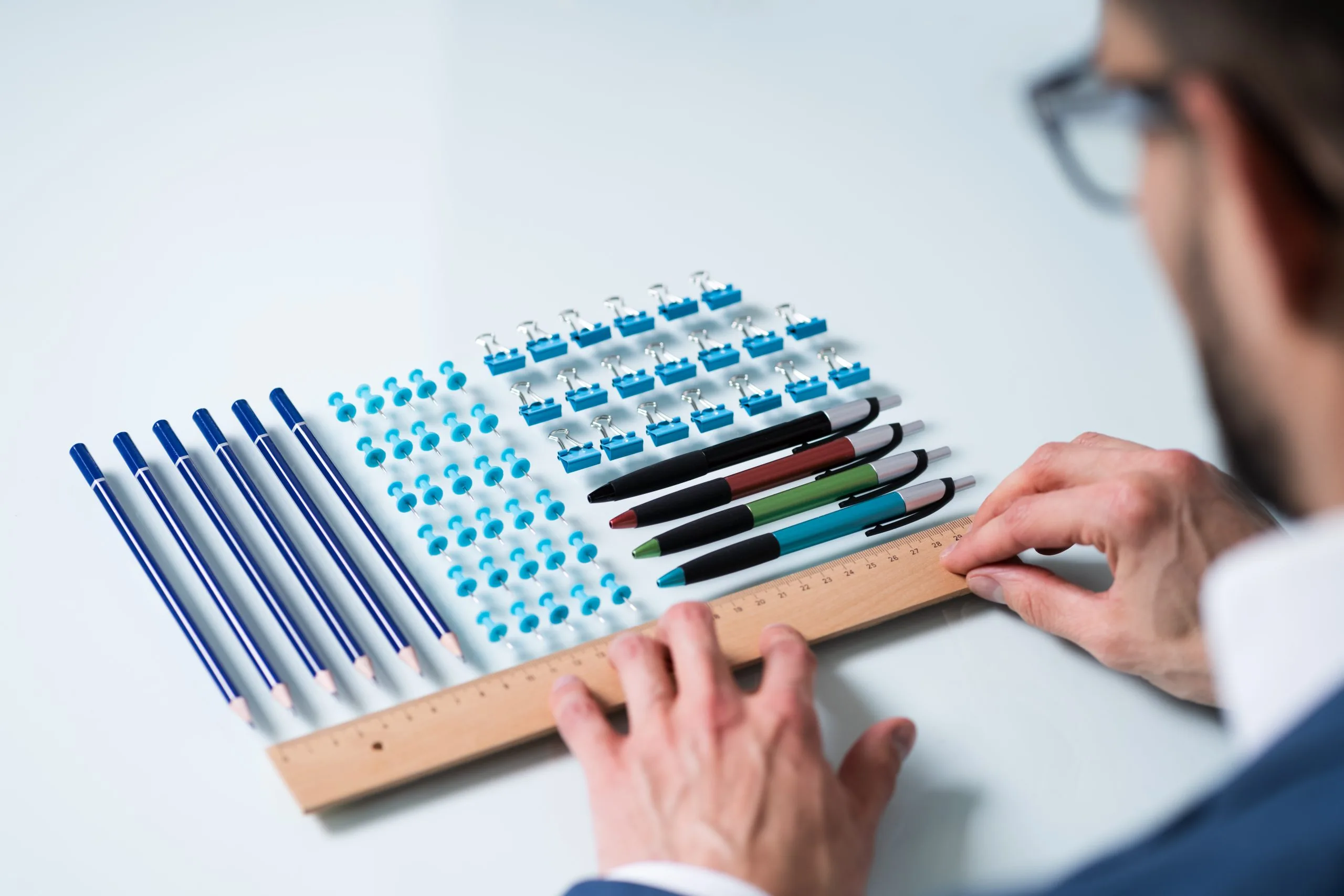 Pens arranged in neat rows on a desk