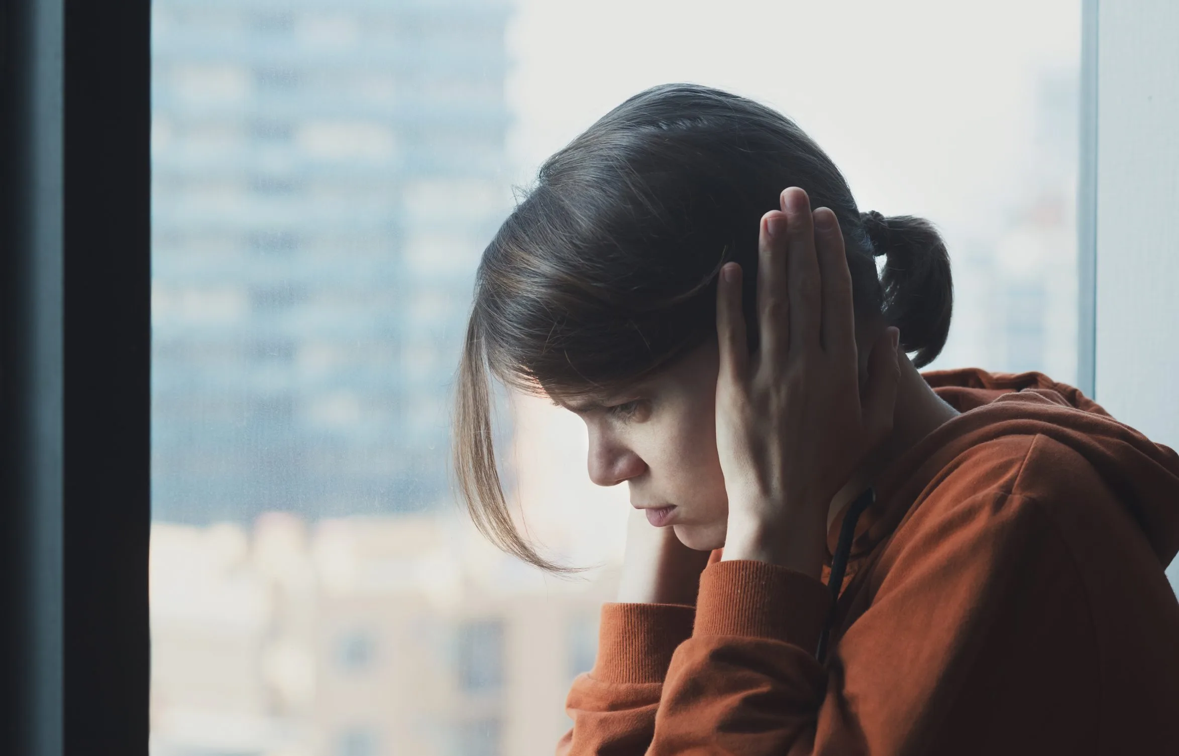 Young girl covering her ears