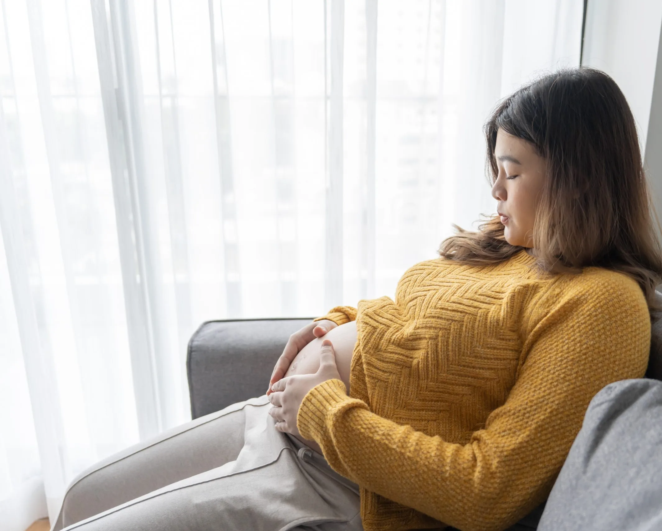 Pregnant woman resting on a couch