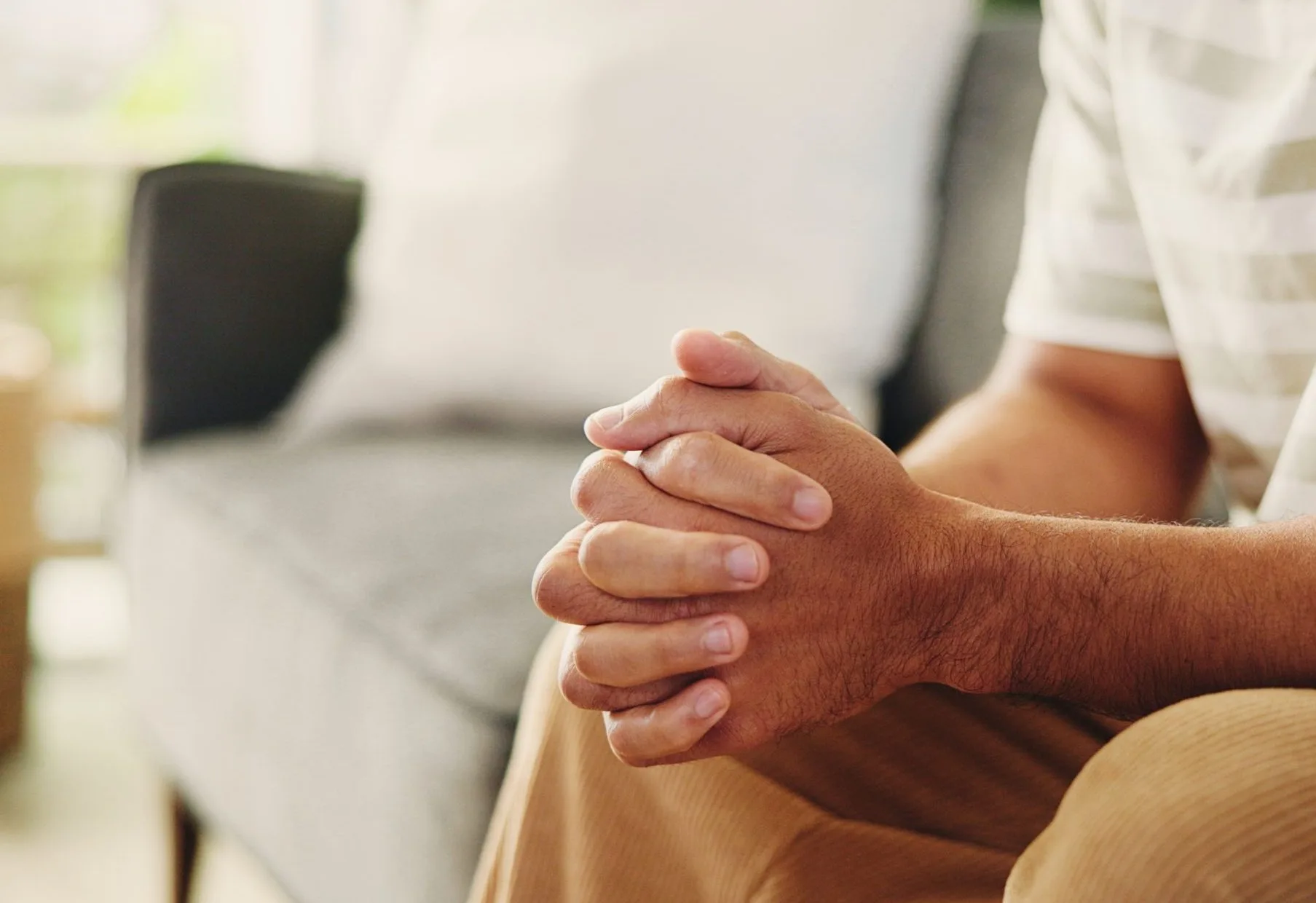 Close-up of a man's clasped hands