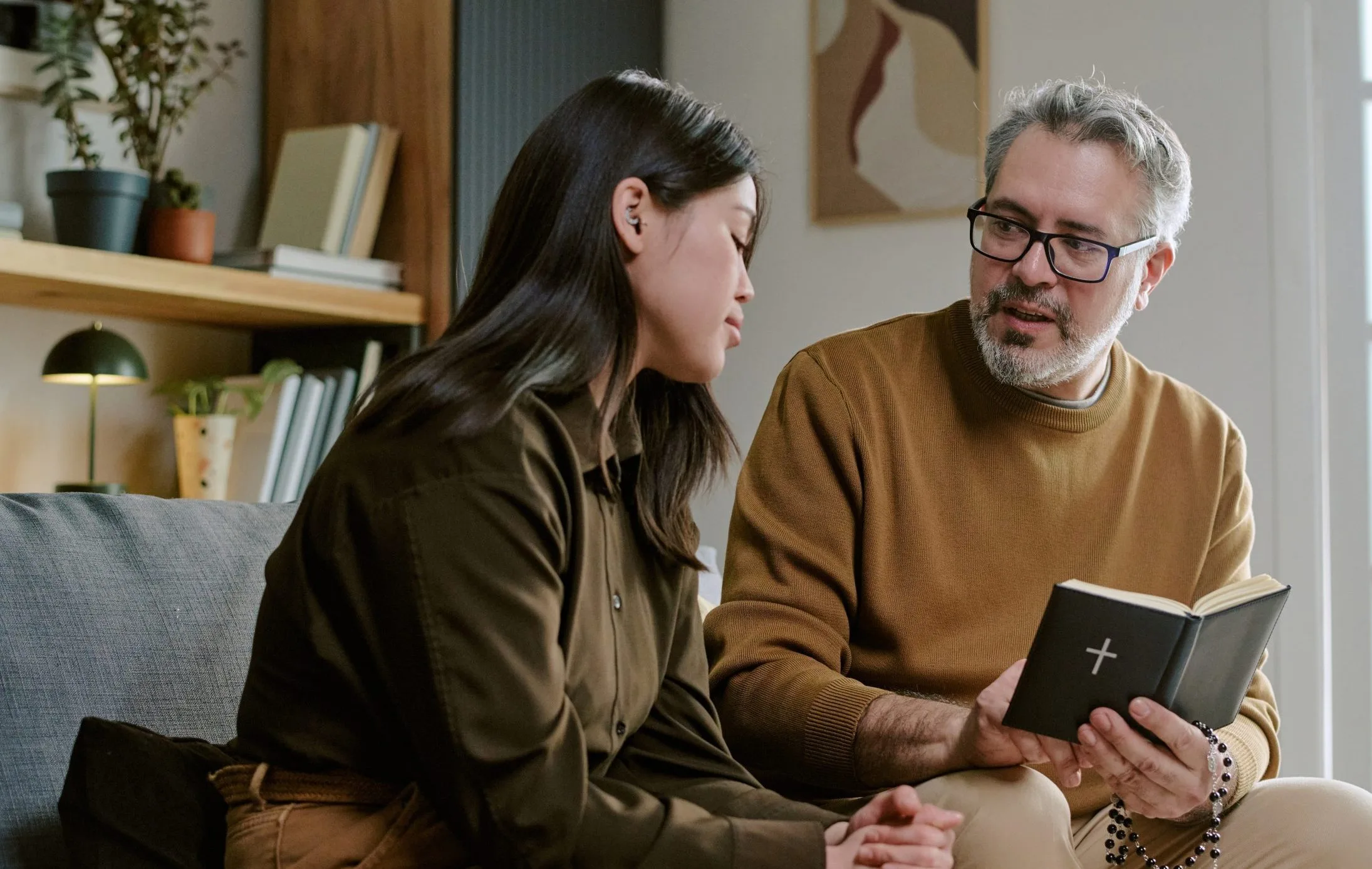 Woman and older man discussing a book