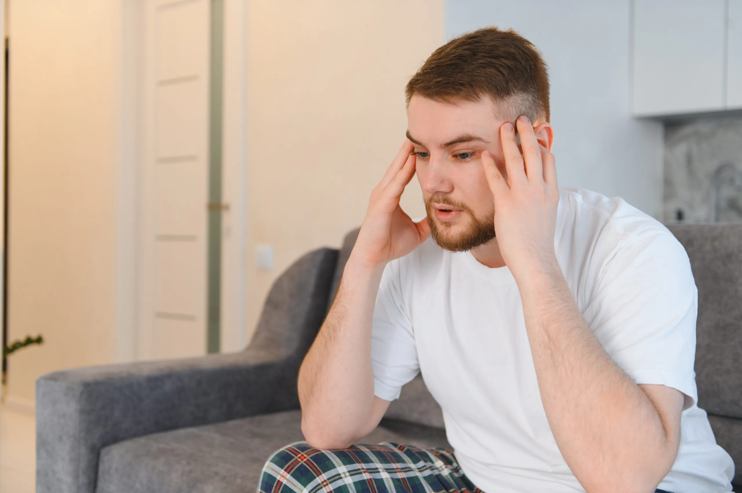 Distressed man holding his head