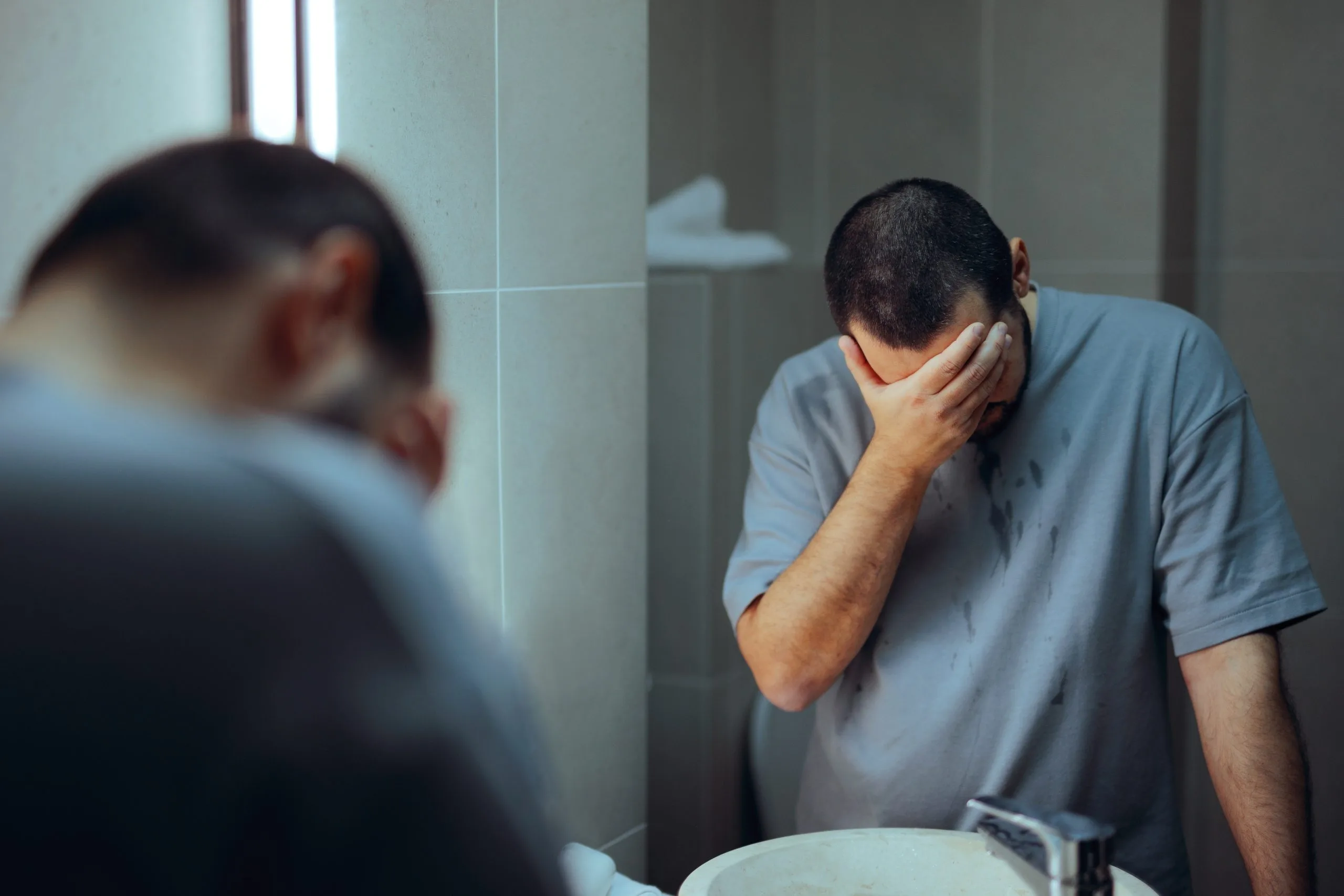 Man covering his face during a therapy session