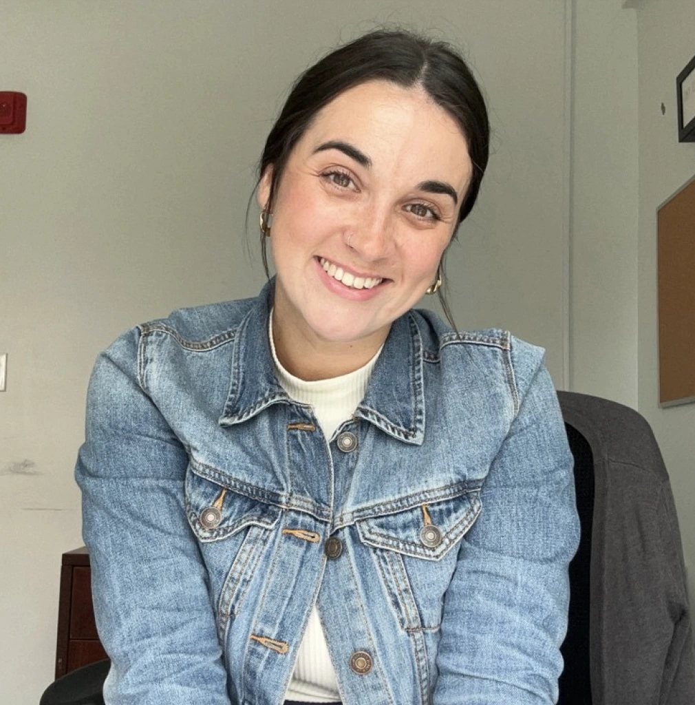 Molly Conway, LMHC, smiling at the camera in a clinical office setting