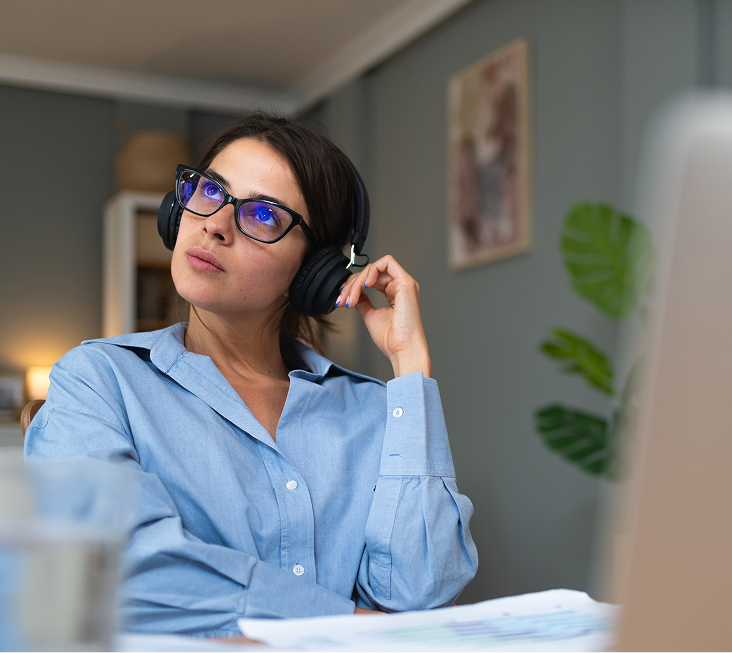 Woman wearing headphones and glasses during ADHD testing in a clinical office