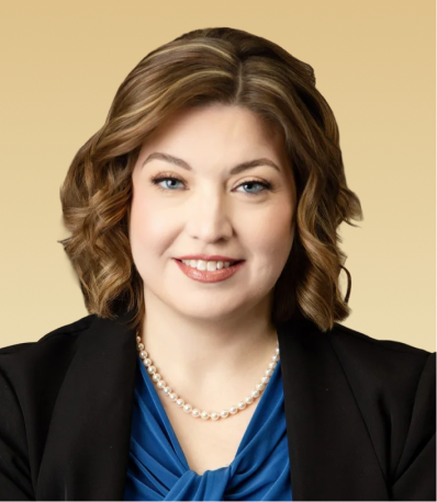 Michelle Kachman, smiling professional headshot wearing blue top and pearl necklace