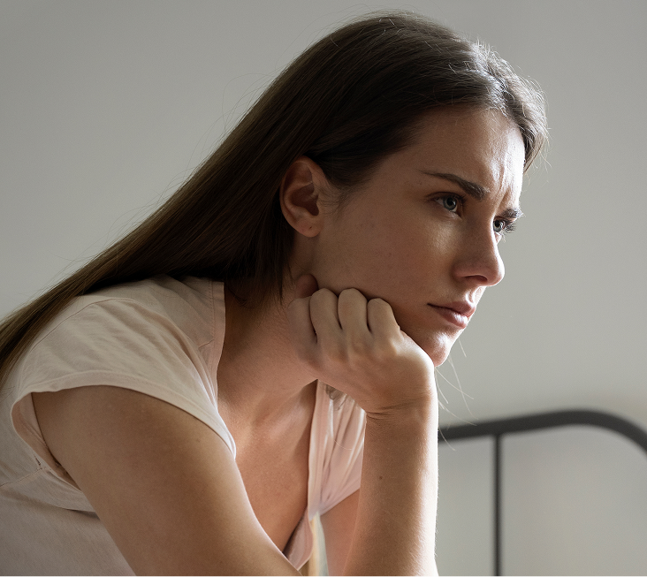 Woman in thoughtful pose with hand to face, representing psychodynamic therapy approach