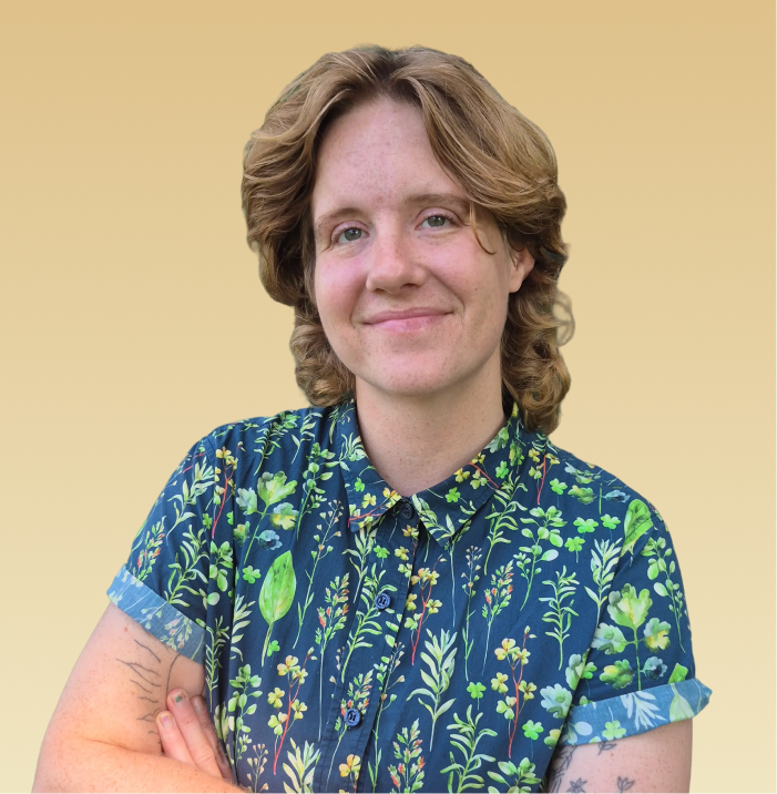 Riley Dean, LMSW, smiling at camera wearing a blue floral shirt against a tan background