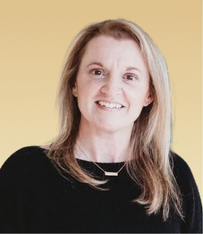 Team member smiling at camera against yellow background