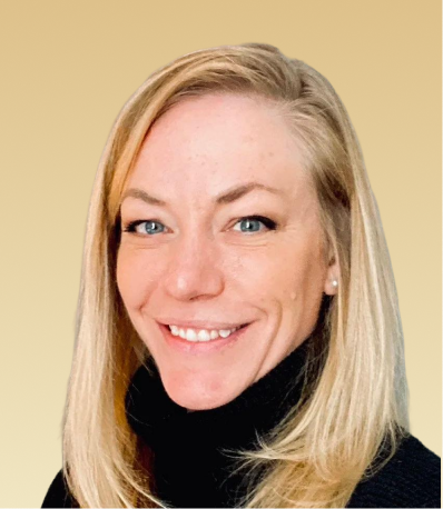 Team member with blonde hair smiling at camera against beige background