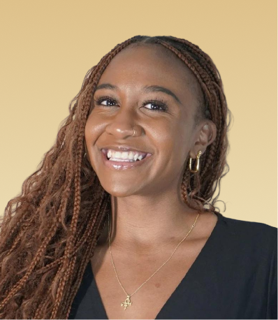 Team member smiling at camera against beige background