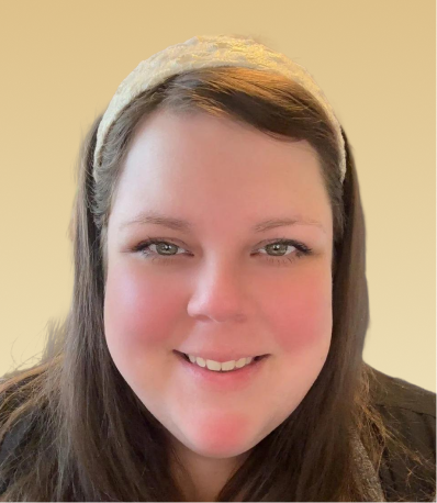 Team member smiling at camera against neutral background