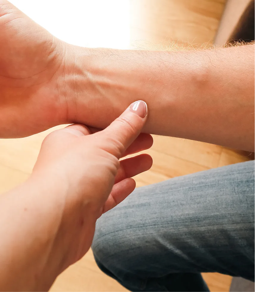 Parent's hand palpating a child's arm to check for lumps or swelling