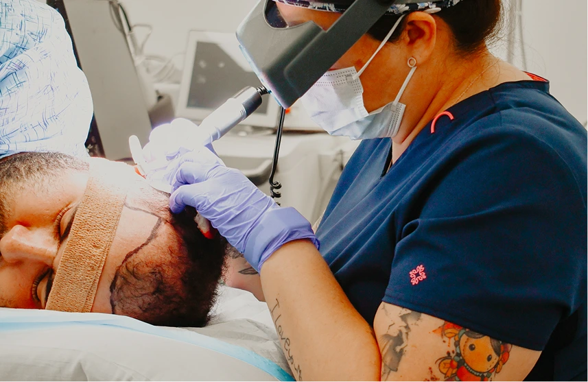 Practitioner using handheld laser device on patient's face during hair removal treatment