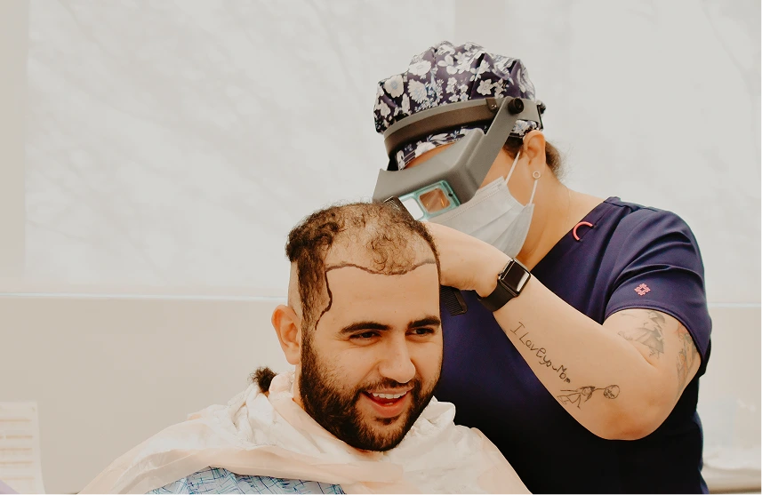 Clinician applying laser hair growth device to patient's scalp