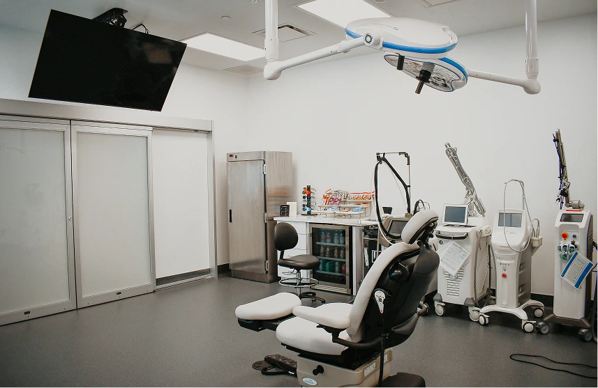 Medical treatment room with specialized hair restoration equipment and procedure chair
