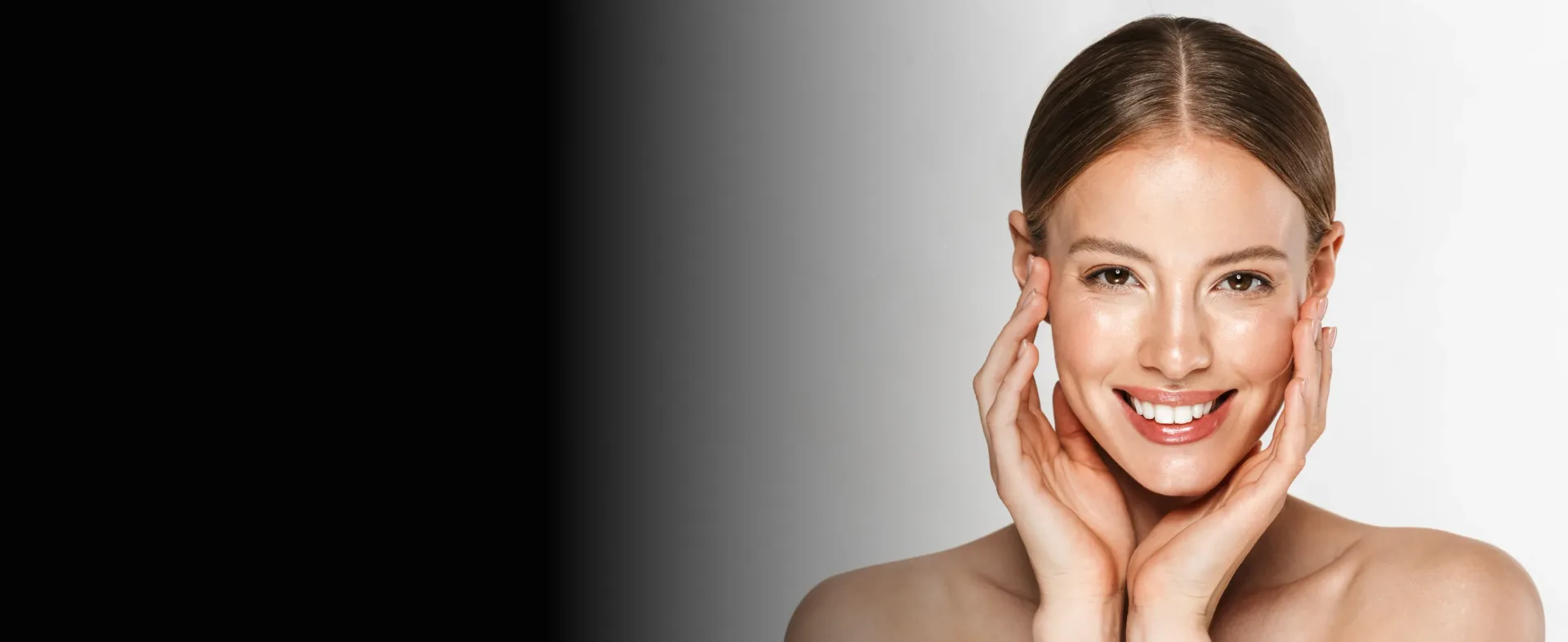 Woman with clear skin touching her face and smiling