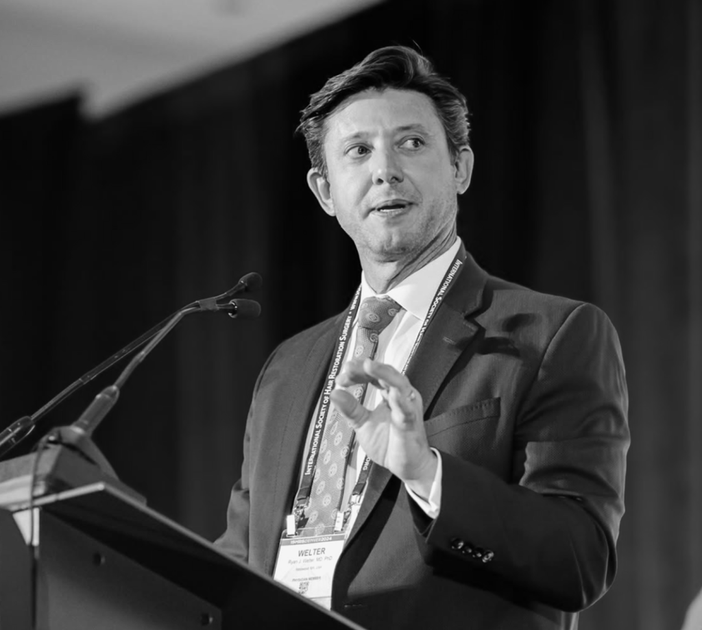 Dr. Ryan speaking at a podium during a professional presentation
