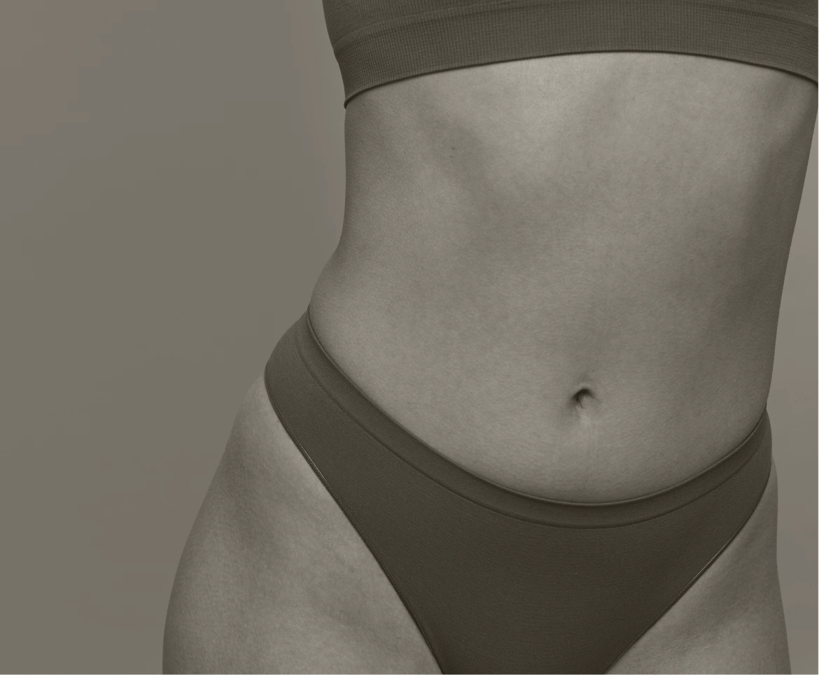Person's torso showing defined abdominal contours and waistline