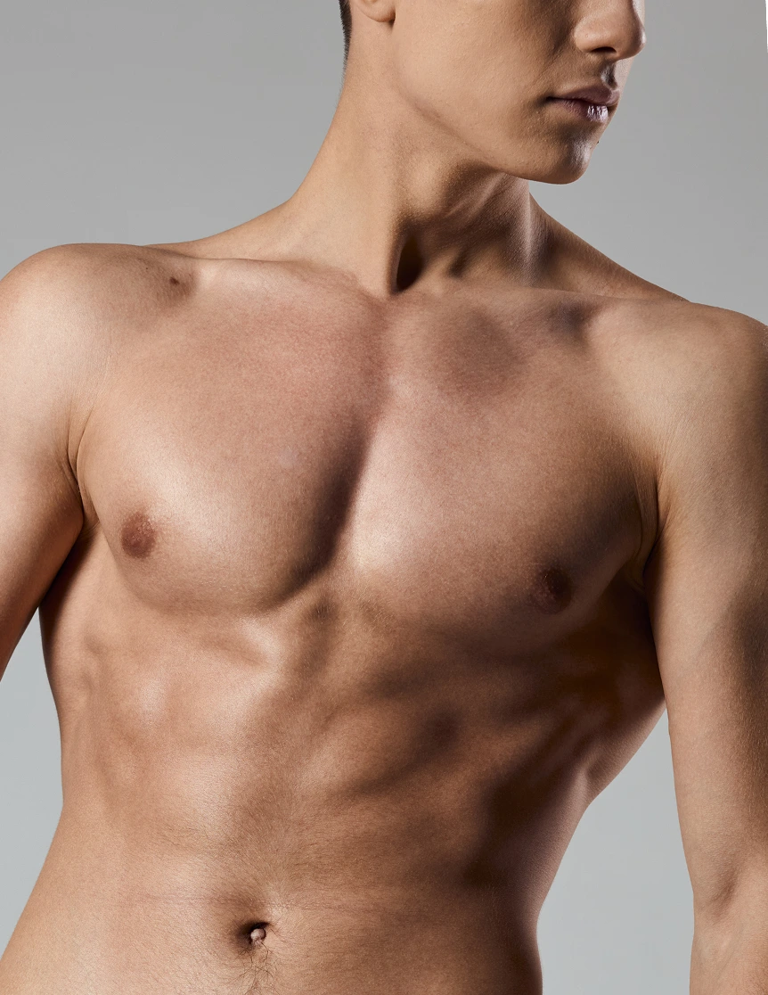 Shirtless man in profile showing defined chest and abdominal muscles