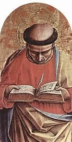 Medieval religious figure in brown robes reading an open book